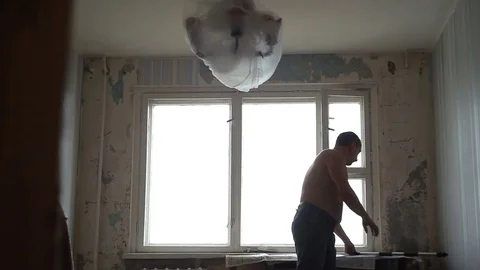 A man cleans the ceiling Stock Footage 83304903