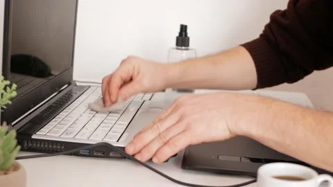 Man cleans computer keyboard, a product and a napkin for washing screens Video stock 165045981