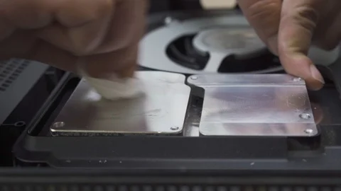 A man cleans the cooling system of the old thermal paste Stock Footage 108663247