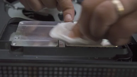 A man cleans the cooling system of the old thermal paste close-up Stock Footage 108663339