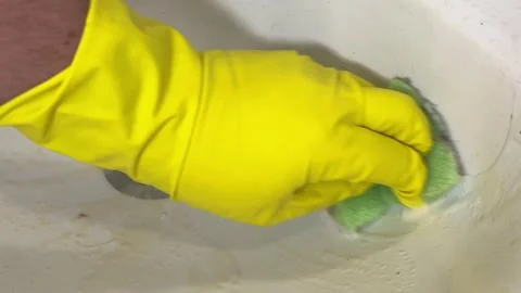 Man cleans dirty ceramic white sink with yellow plaque Stock Footage 299932006