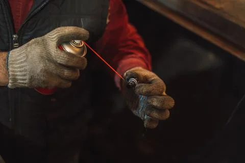 Man cleans the engine plug with solution from soot Stock Photos