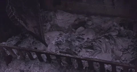 Man cleans the fireplace ash / Burnt Wood - 4K closeup Stock Footage 151122905