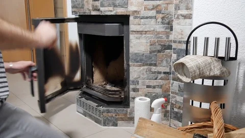 Man cleans the fireplace from the ash Stock Footage 100723401
