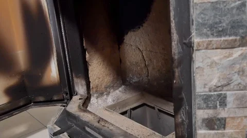 A man cleans the fireplace from the ash Stock Footage 100728435