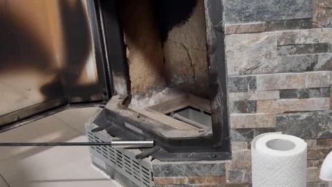 A man cleans the fireplace from the ash Vídeos de archivo 100728862