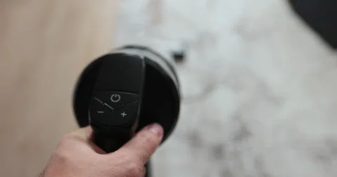 Man cleans the floor with a vacuum cleaner with a battery. House cleaning Video stock 256977403
