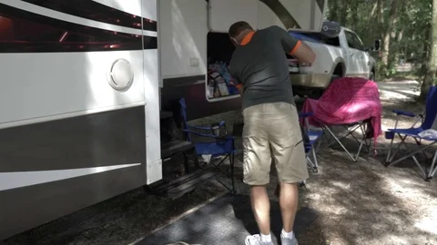 Man Cleans in Front of 5th Wheel RV Stock Footage 80533797