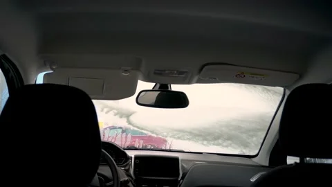 Man cleans the front window of the car with pressurized water- Stock Footage 166794177