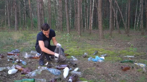 Man cleans garbage in forest Stock Footage 118264646