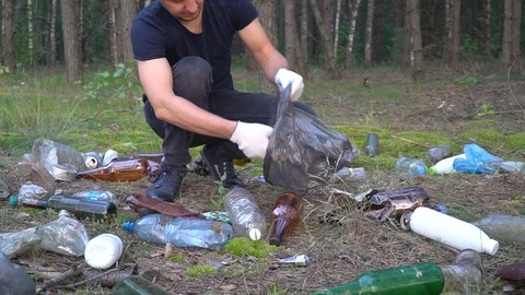 Man cleans garbage in forest Stock Footage 118319210