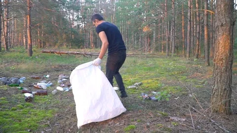 Man cleans garbage in forest Stock Footage 118319334