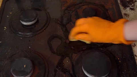 Man cleans gas stove Stock Footage 112992293