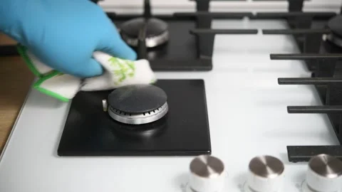 A man cleans a gas stove in the kitchen. Video stock 299567191