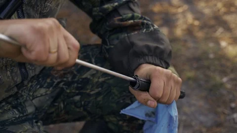 A man cleans a gun Stock Footage 117145155