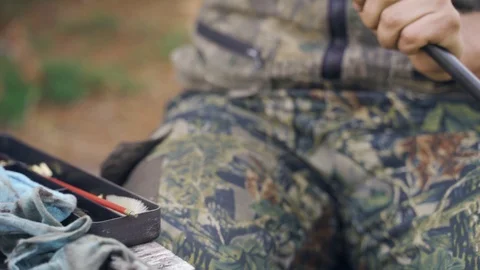 A man cleans a gun Stock Footage 117145195