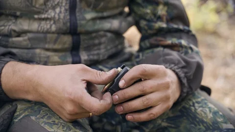 A man cleans a gun Stock Footage 117145377