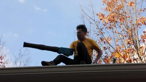 A man cleans gutters Stock Footage 221957177