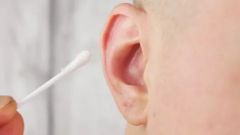 A man cleans his right ear close-up. Ear care hygiene. Stock Footage 186145159