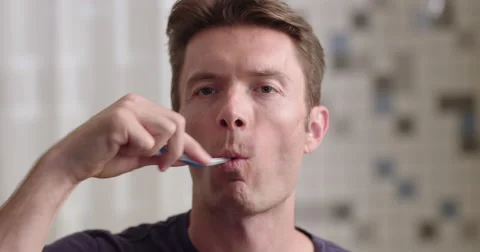 Man cleans his teeth in slow motion close up 4K Stock Footage 66500038