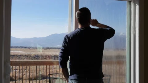 A man cleans house windows during the day Stock Footage 57876879