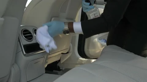 Man cleans inside of luxury car Stock Footage