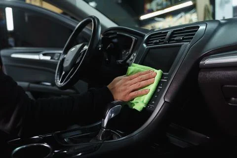 Man cleans interior of car Stock Photos