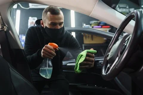 Man cleans interior of car Stock Photos