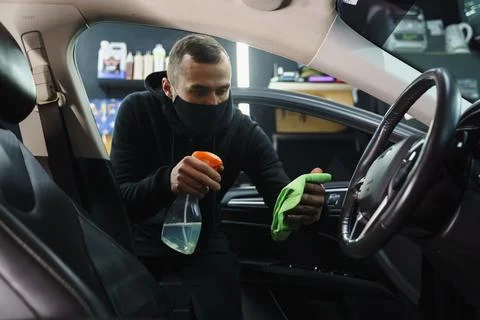 Man cleans interior of car Stock Photos
