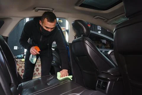 Man cleans interior of car Foto stock