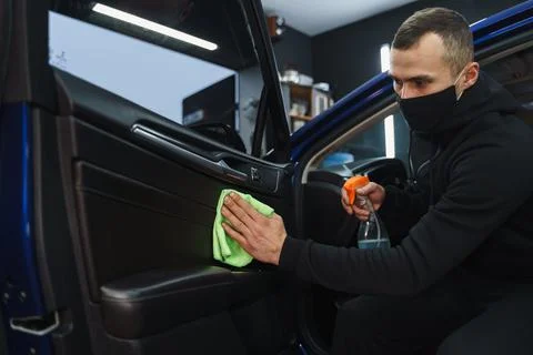 Man cleans interior of car Stock Photos