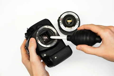A man cleans the matrix of a SLR camera Stock Photos