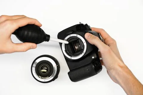A man cleans the matrix of a SLR camera Stock Photos