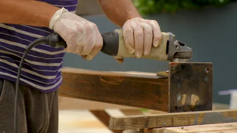 A man cleans metal with a grinder. Selective focus. Stock Footage 246904578