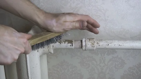 A man cleans an old battery from rust Stock Footage 116129102