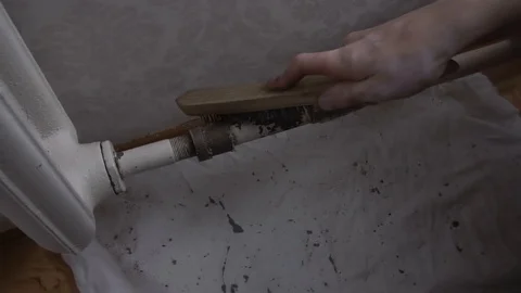 A man cleans an old battery from rust Stock Footage 116129196