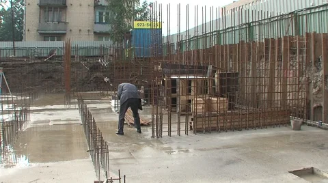 Man cleans the pants leg at a construction site Stock Footage 5165070