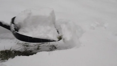 A man cleans a path with shovel Stock Footage 122454250