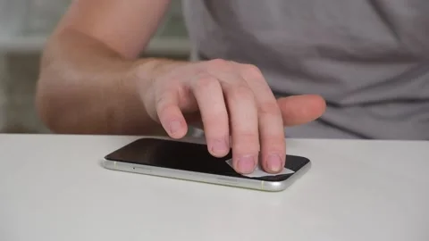 Man cleans phone screen stick protective tempered glass. Broken glass iPhone XR Stock Footage 236423657