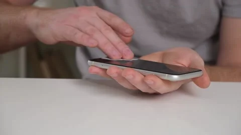 Man cleans phone screen stick protective tempered glass. Broken glass iPhone XR Stock Footage 236920544