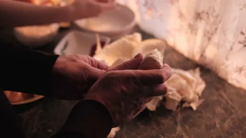 A man cleans a piece of pomelo with his hands in the kitchen Stock Footage 162714838