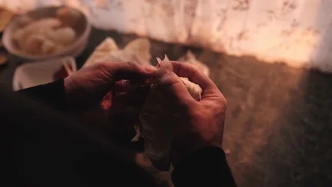 A man cleans a piece of pomelo with his hands in the kitchen Stock Footage 162714883