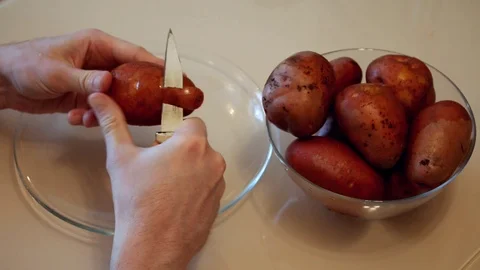 Man cleans the potatoes. Hands clean potatoes Stock Footage 87506917