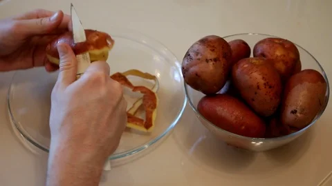 Man cleans the potatoes. Hands clean potatoes Stock Footage 87599308