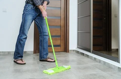 The man cleans the room. Stock Photos