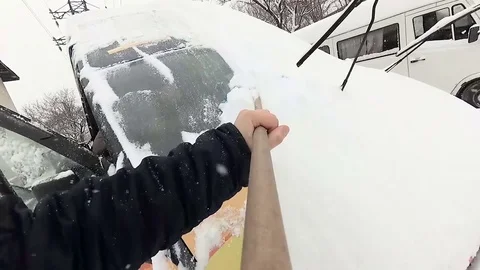 Man cleans snow from the car Stock Footage 85133516