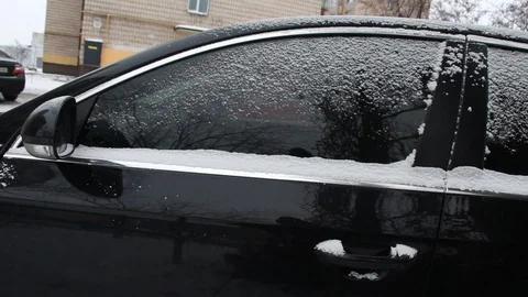 Man cleans the snow with his black car Stock-Footage 101807843
