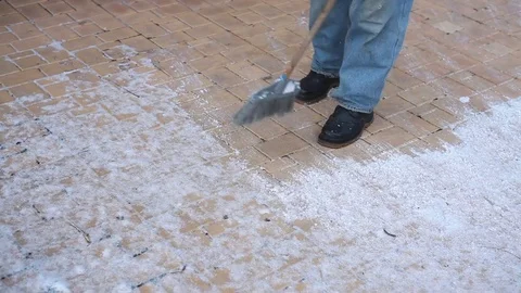 Man cleans snow from the sidewalk Stock Footage 84711363