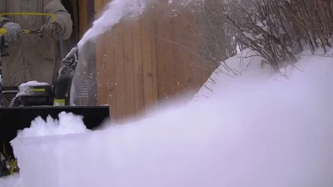 A man cleans snow from sidewalks with snowblower Video stock 84666428