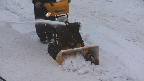 A man cleans snow from sidewalks with snowblower. 스톡 동영상 85835977